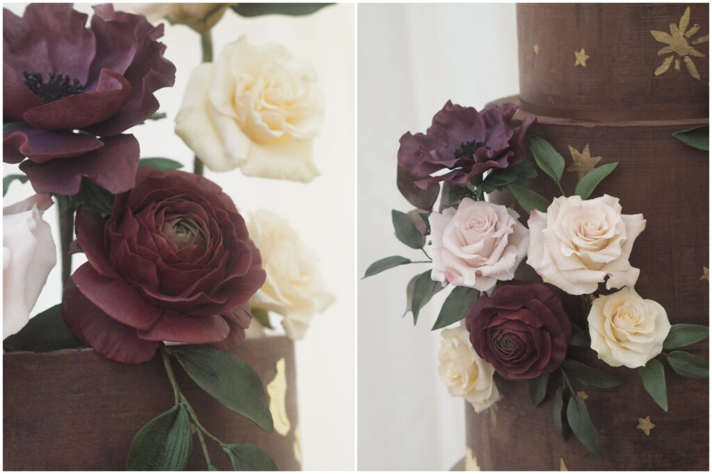a chocolate ganache cake with painted star detailing, burgundy ranunculus, aubergine anemone, dusky pink roses and ivory spray roses