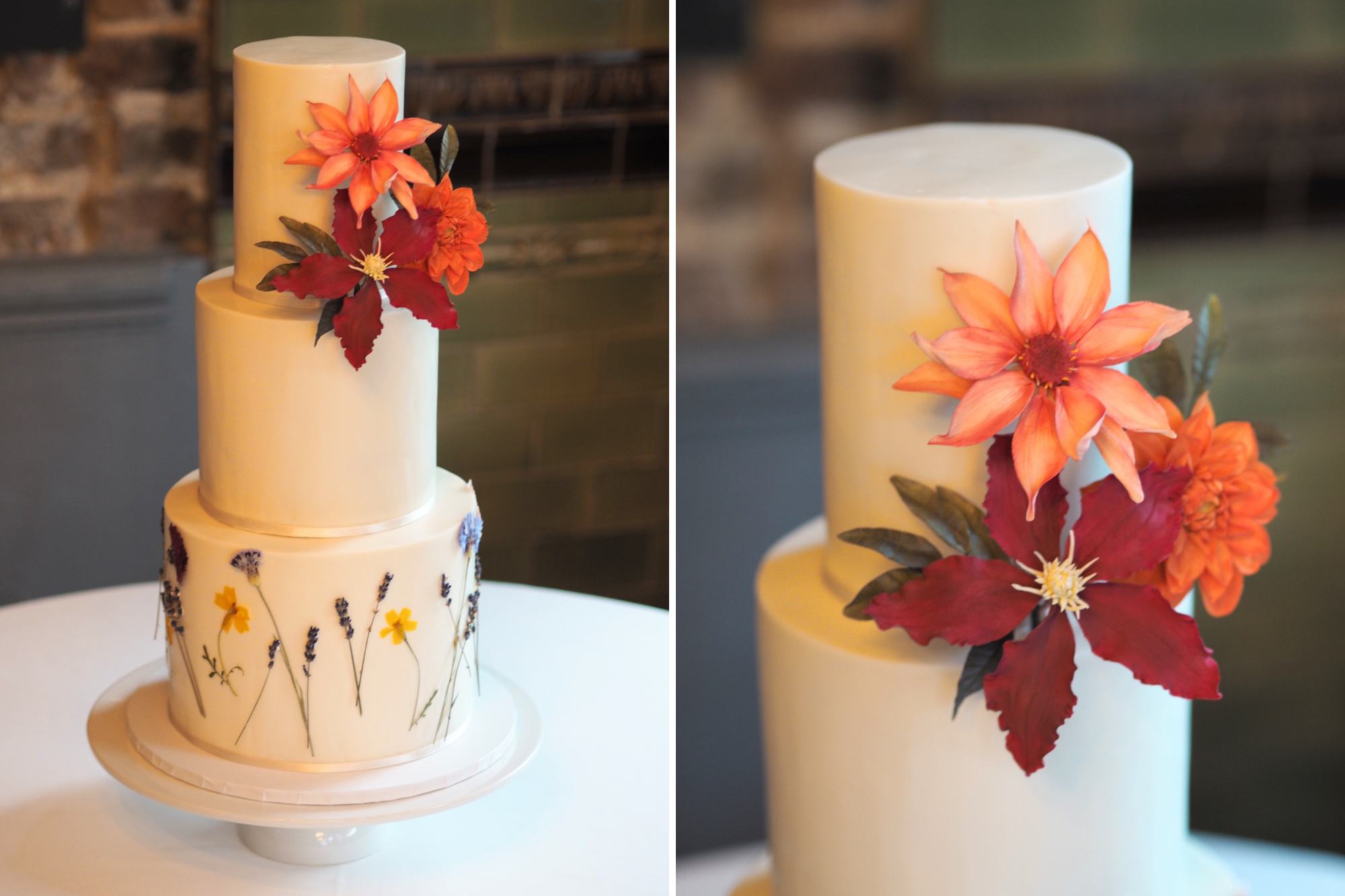 An ivory 3 tier wedding cake at The Londesborough Pub with pressed edible flowers around the base tier and a statement handcrafted sugar flower arrangement: burgundy clematis and peach orange dahlias