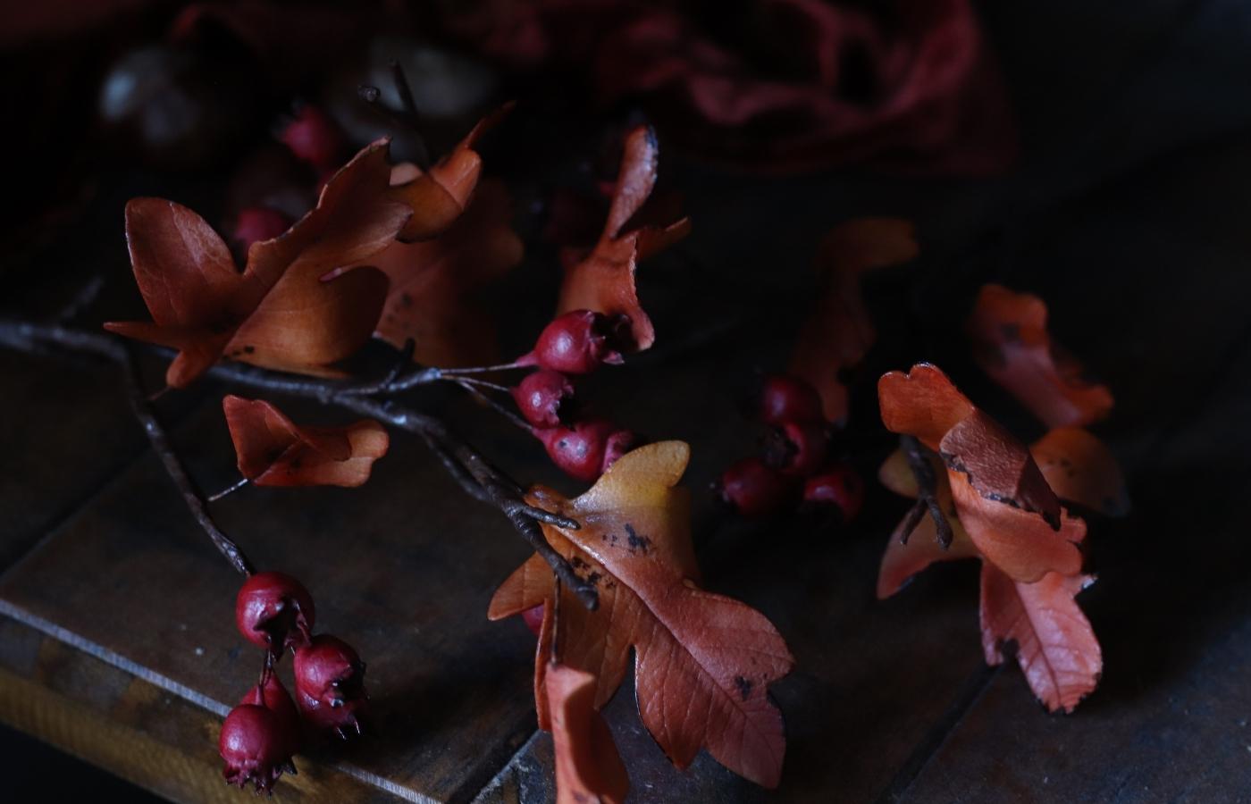 Autumn inspired red hawthorn berries and orange leaves made from gumpaste