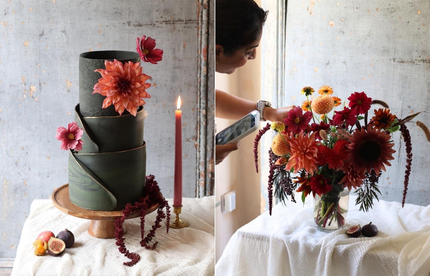 a 3 tier dark green wedding cake with statement peach dahlia and pink cosmos sugar flowers next to a candle; a lady putting the final touches to a bouquet of flowers