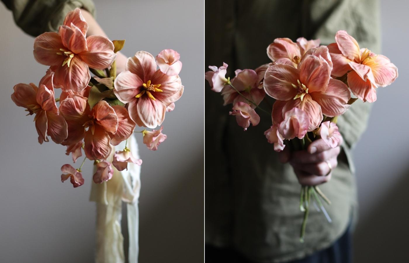 Handheld bouquet of reflexed tulip sugar flowers made from gumpaste in soft peach and coral tones